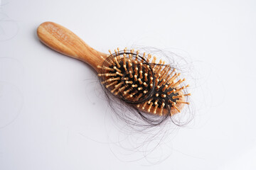 Hair loss fall with comb brush isolated on white background.