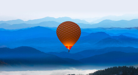 Beautiful mountain landscape with  pine forest at sunset - 
Hot air balloon fly over blue mountains