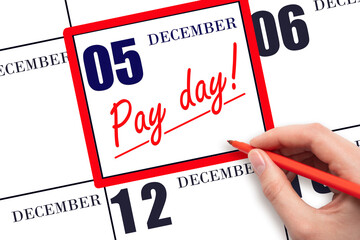 Hand writing text PAY DATE on calendar date December 5 and underline it. Payment due date