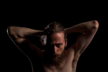Hipster with long beard on black background in studio photo. Expression and fashion