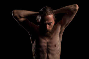 Hipster with long beard on black background in studio photo. Expression and fashion