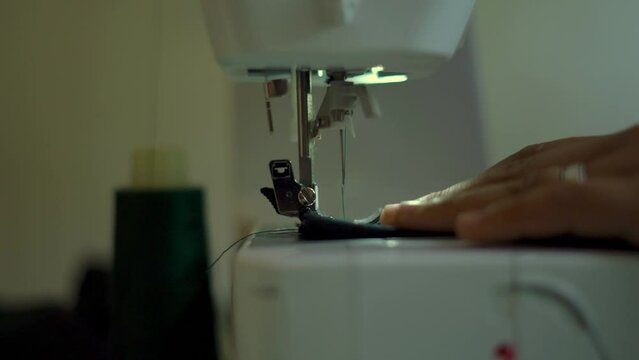 hand on sewing machine