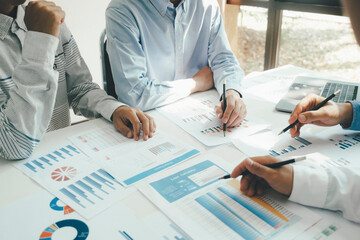 Businessmen working together at desk.