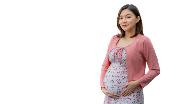 Happy young pragnent Asian woman in maternity clothes smiling and standing in front of a white background