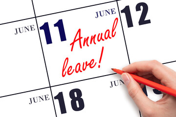 Hand writing the text ANNUAL LEAVE and drawing the sun on the calendar date June 11