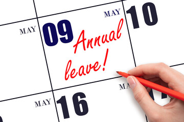 Hand writing the text ANNUAL LEAVE and drawing the sun on the calendar date May 9