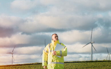 engineer man stands in a wind turbine field.