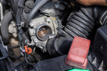 Fototapeta premium Repair and cleaning work of a car throttle body