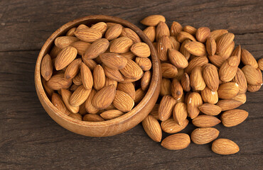 Raw Organic almonds on rustic wood table.Top view
