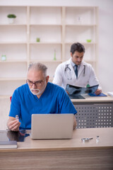 Fototapeta premium Two male doctors working in the clinic