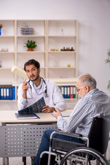 Old injured man visiting young male doctor radiologist