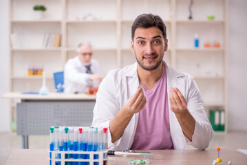 Two male chemists working at the lab