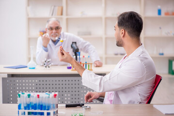 Two male chemists working at the lab