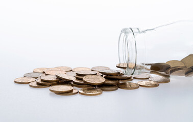 Coins spilling from glass jar