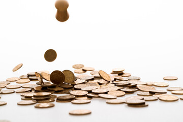 Golden coins falling on white background