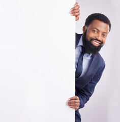 Hiding, portrait and a black man standing by a wall isolated on a white background in a studio....