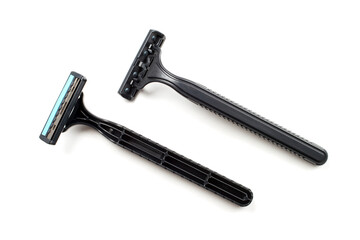 Two disposable plastic razors on a white background. Black disposable razors.