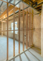 Vertical Under construction basement with hardwood frames and plastic vapor barrier