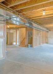 Vertical Large unfinished basement with woodframes and wall insulation
