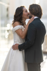 Wedding couple kissing City. Dawn. Wedding dress. Bride & groom. 