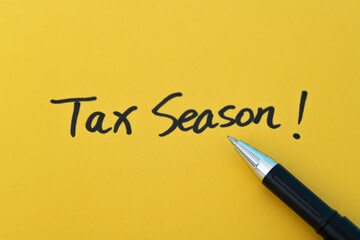 Tax season written on yellow paper
