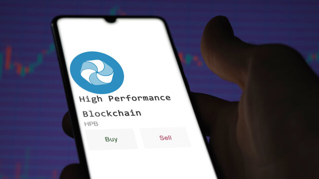 March 11 2023 London UK. An investor's analyzing the High Performance Blockchain  coin on screen. A phone shows the ETF's prices to invest in HPB