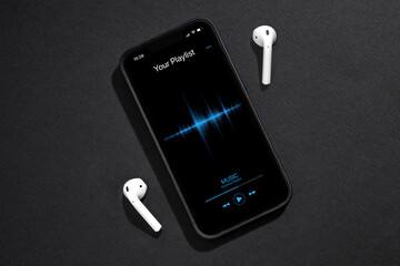 Smartphone with music player app on dark grey background