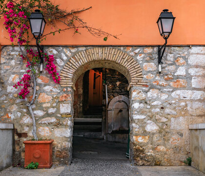 Stone arch in a terracotta wall in the Old Town of Villefranche sur Mer, France