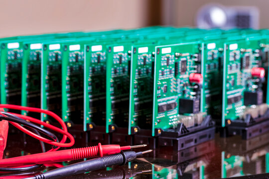 Printed Circuit Board with SMD Components. Placed with Connected Wire Probes During a Process of Tesing  in the Lab.
