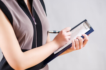 Business Ideas. Closeup of Hands of One  Caucasain Woman Writing on Paper Sheet on Notepad