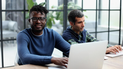 Fototapeta na wymiar Two men colleagues sharing creative ideas, using digital tablet