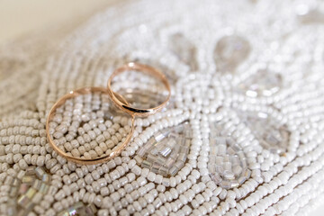 wedding rings on a beaded table
