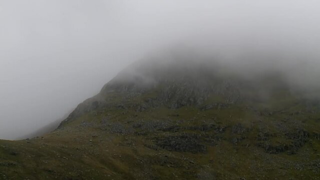 A shot of the mist and fog rolling over a mountain near the village of Tarbert on the Isle of Harris, part of the Outer Hebrides of Scotland.