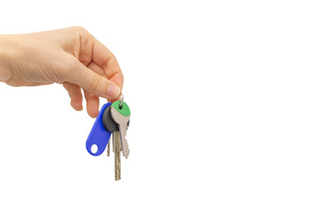 Woman's hand holding keys on a white background