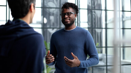 Headshot portrait of a smiling businessman offering a handshake. Business concept