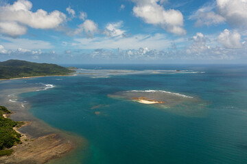 Fototapeta na wymiar Sandy island in the blue sea. Crocodile island. Santa Ana, Cagayan. Philippines.