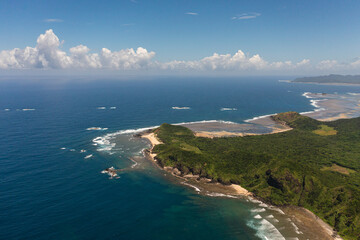 Aerial drone of tropical island with jungle and blue sea. Cape Engano. Palaui Island. Santa Ana Philippines.