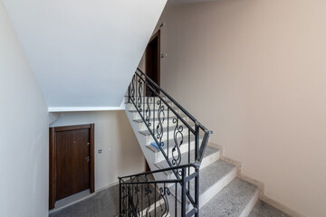 Modern stair case between floors. Stairs with metallic rail in modern building