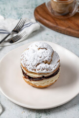 Cake with cream and liquid chocolate filling. Powdered Sugar Cake.