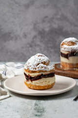 Cake with cream and liquid chocolate filling. Powdered Sugar Cake.