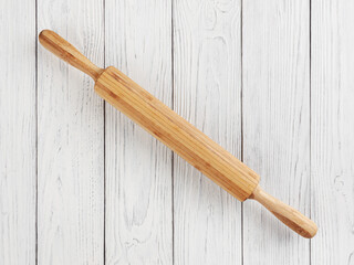 Rolling pin on white wooden background