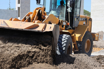 Bulldozer Pushing Dirt at Construction Site © Bill McKeon