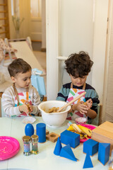 Kids prepering food in the montessori  kindergarten,  banana cokies