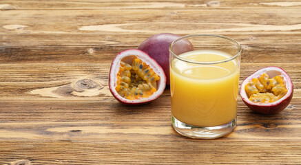 Fresh passion fruit juice on a wooden table.