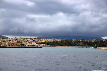 Fototapeta na wymiar Procida Island on a rainy day with dramatic clouds