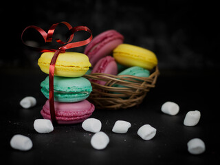 Macaroons on a dark background, multicolored macaroons Macaroons. A gift for March 8