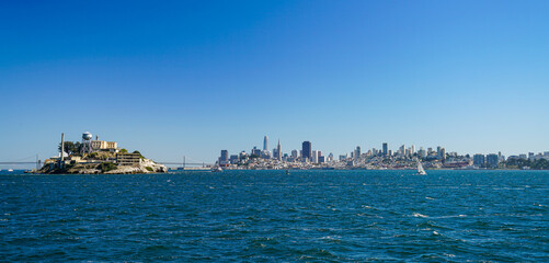 Skyline from San Francisco with Alcatraz island, taken from the water on a sunny day with blue sky