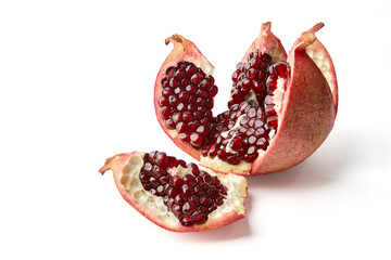 Beautifully cut broken ripe pomegranate isolated on white background