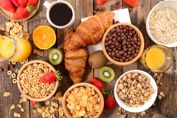 Selection of various corn flakes for breakfast with croissant and coffee cup