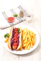 Hot dog( bread, sausage, red cabbage and ketchup) with french fries